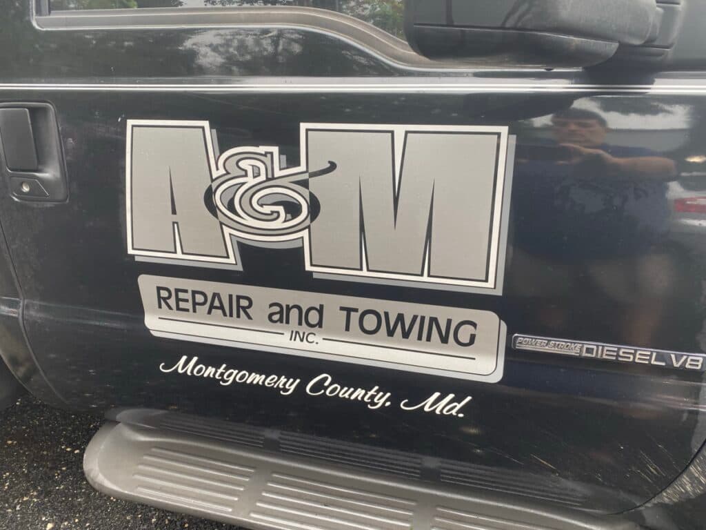 A&M Repair and Towing logo decal on a service truck door