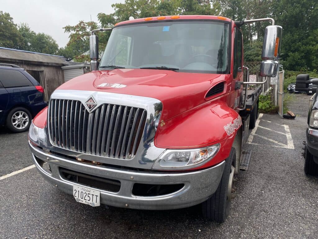 A&M Repair & Towing red International flatbed tow truck
